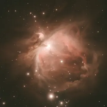 Jigsaw puzzle: A vast, luminous nebula of gas and dust glows with many scattered stars.