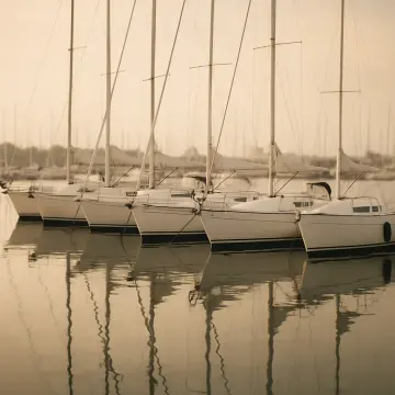 Jigsaw puzzle: Several white sailboats are docked in a marina, their masts reflecting in calm water.